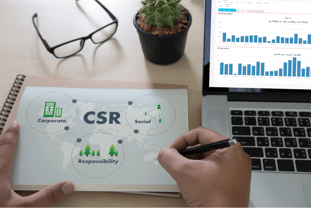 Office worker with their glasses off while they work on a CSR (corporate and social responsibility) report using the LFC Cloud data.